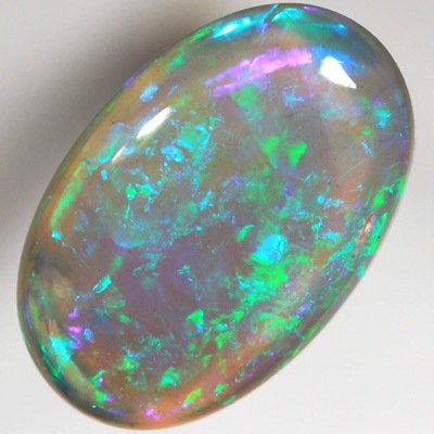 SOLID BLACK CRYSTAL OPAL Very bright greens over a purple hue SEE VIDEO